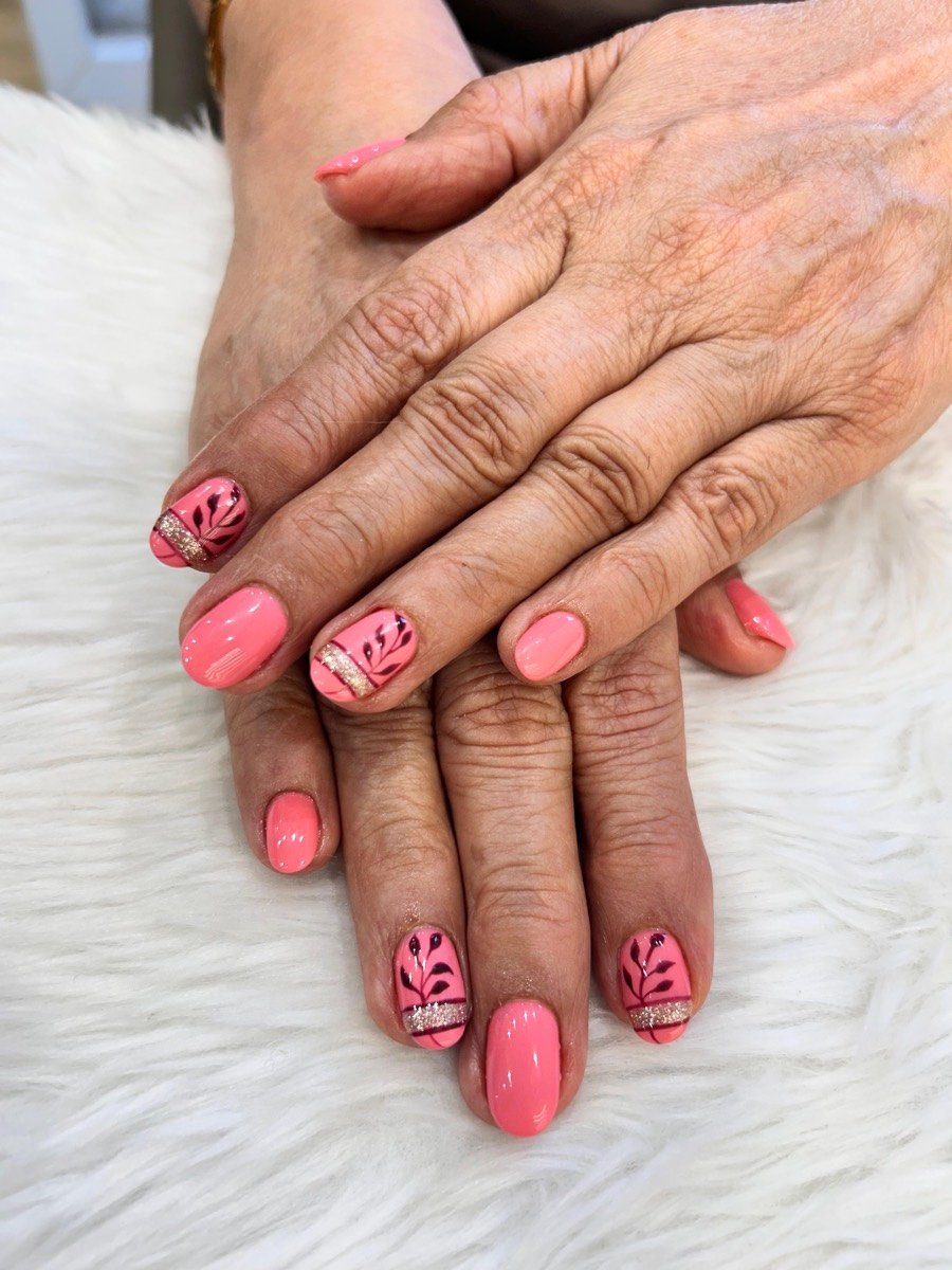 Coral pink nail art with gold leaf detailing